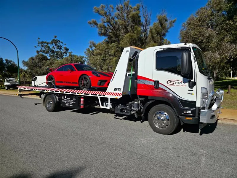 Mini excavator and skid steer loader chained to a heavy plant transport truck