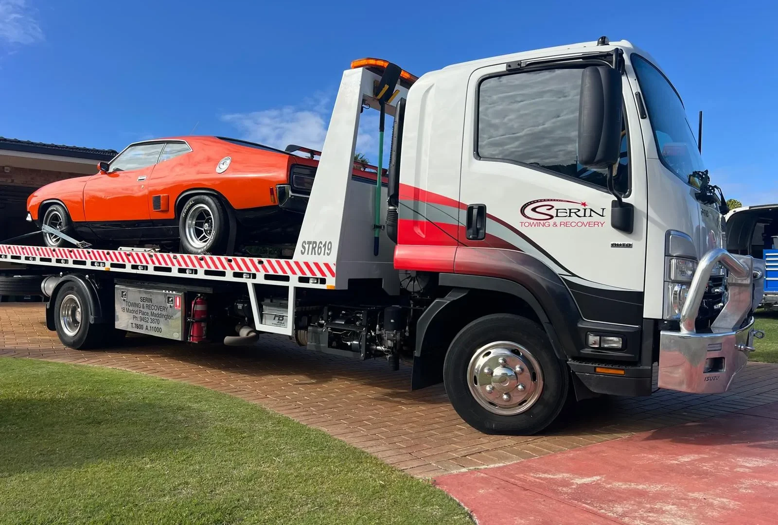Professional loading and restraint of a vehicle on a Serin tilt tray truck in Western Australia